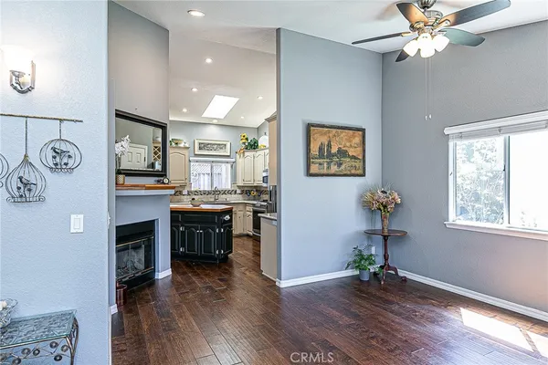 a view of a livingroom with furniture a ceiling fan and wooden floor