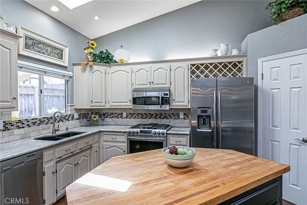 a kitchen with a stove a refrigerator and a sink