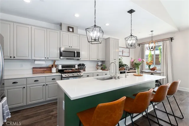 a kitchen with sink cabinets and stainless steel appliances