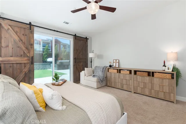 a bedroom with a bed and ceiling fan