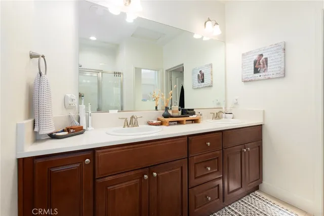 a en suite bathroom with a tub shower and a sink