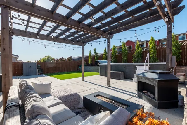 an aerial view of a city with lots of residential buildings and ocean view in back