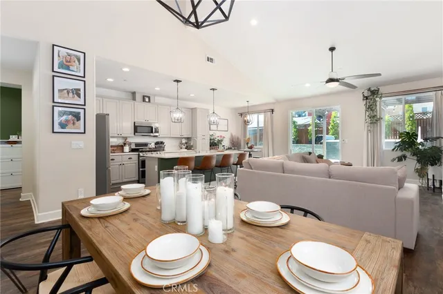 a dining room with furniture and wooden floor