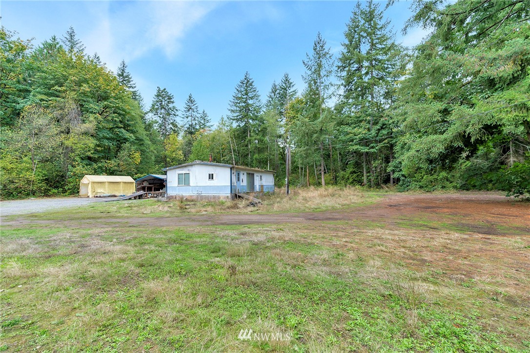 12315 Littlerock Road Southwest Olympia, WA 98512 - Photo 16 of 38 a front view of a house with a yard and trees