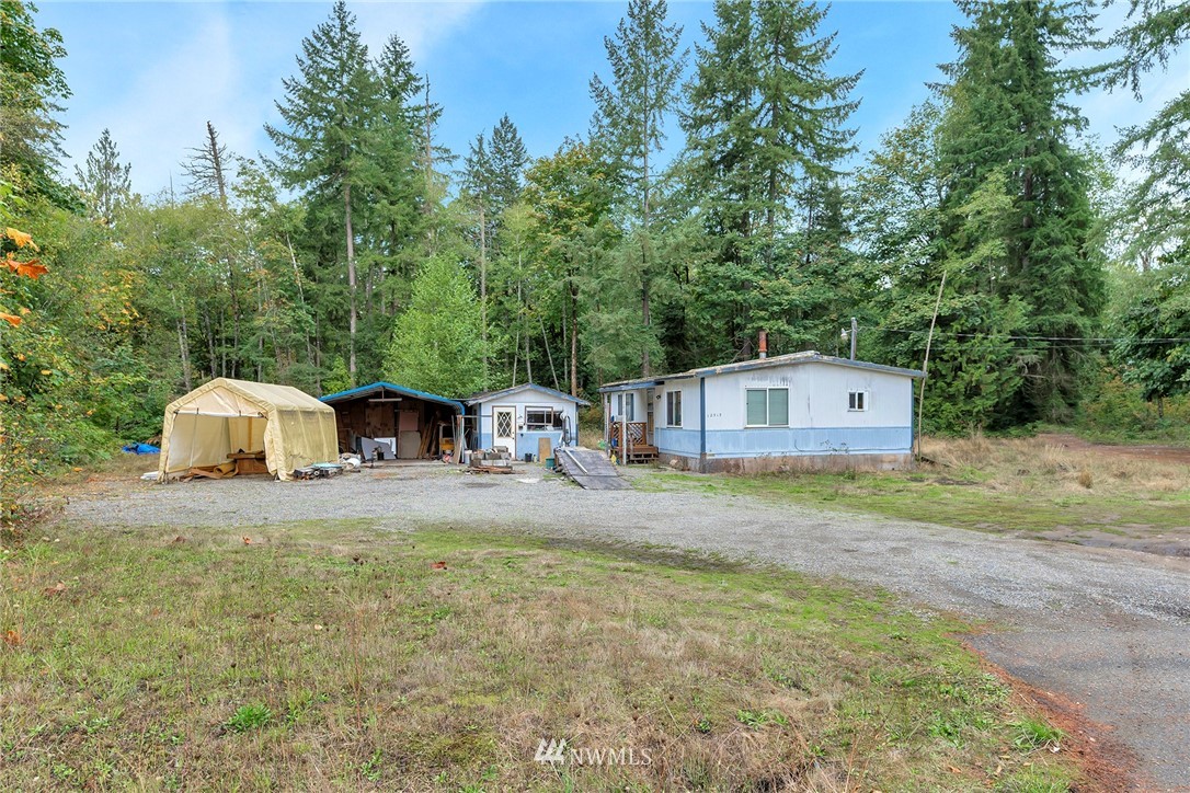 12315 Littlerock Road Southwest Olympia, WA 98512 - Photo 7 of 38 a view of a tiny house with a yard and large trees