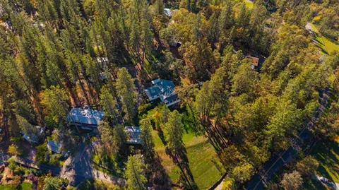 a backyard of a house with lots of green space and fountain