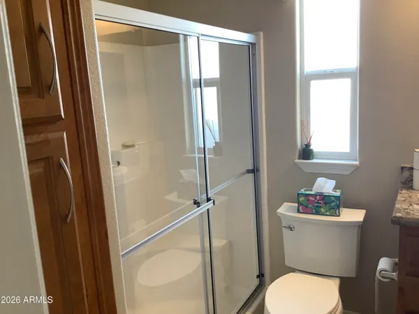 a white toilet sitting next to a bathroom sink
