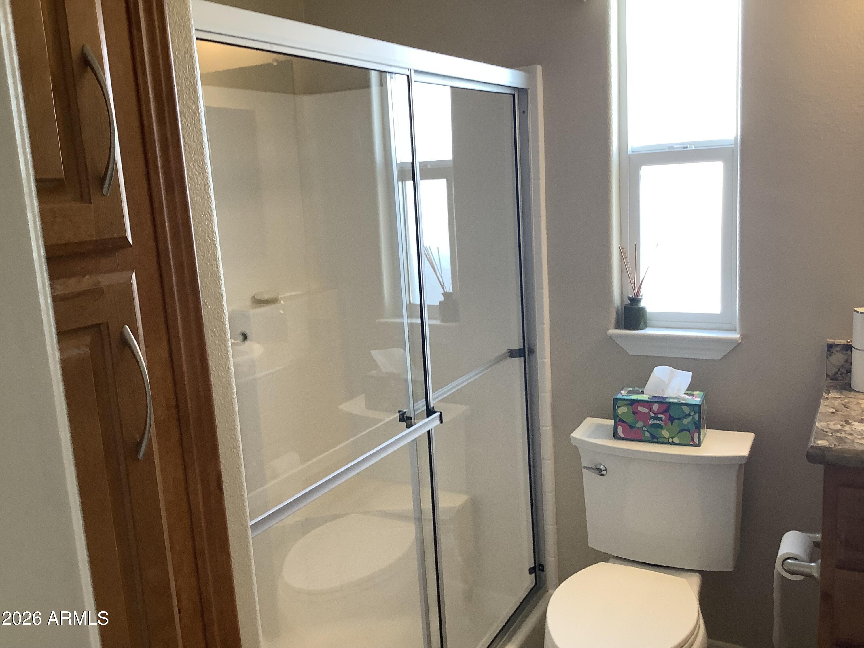 650 North Hawes Road, Unit 4007 Mesa, AZ 85207 - Photo 11 of 42 a white toilet sitting next to a bathroom sink