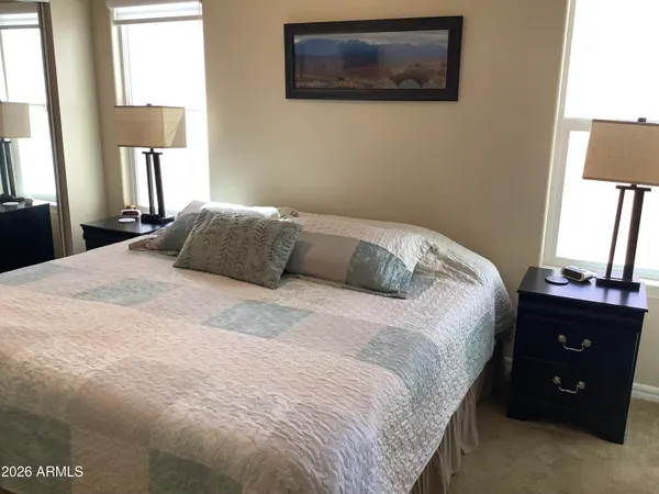 a bedroom with a bed and a window
