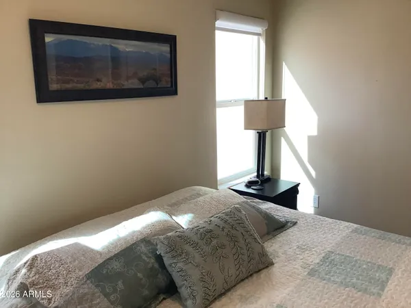 a bedroom with a bed and a window