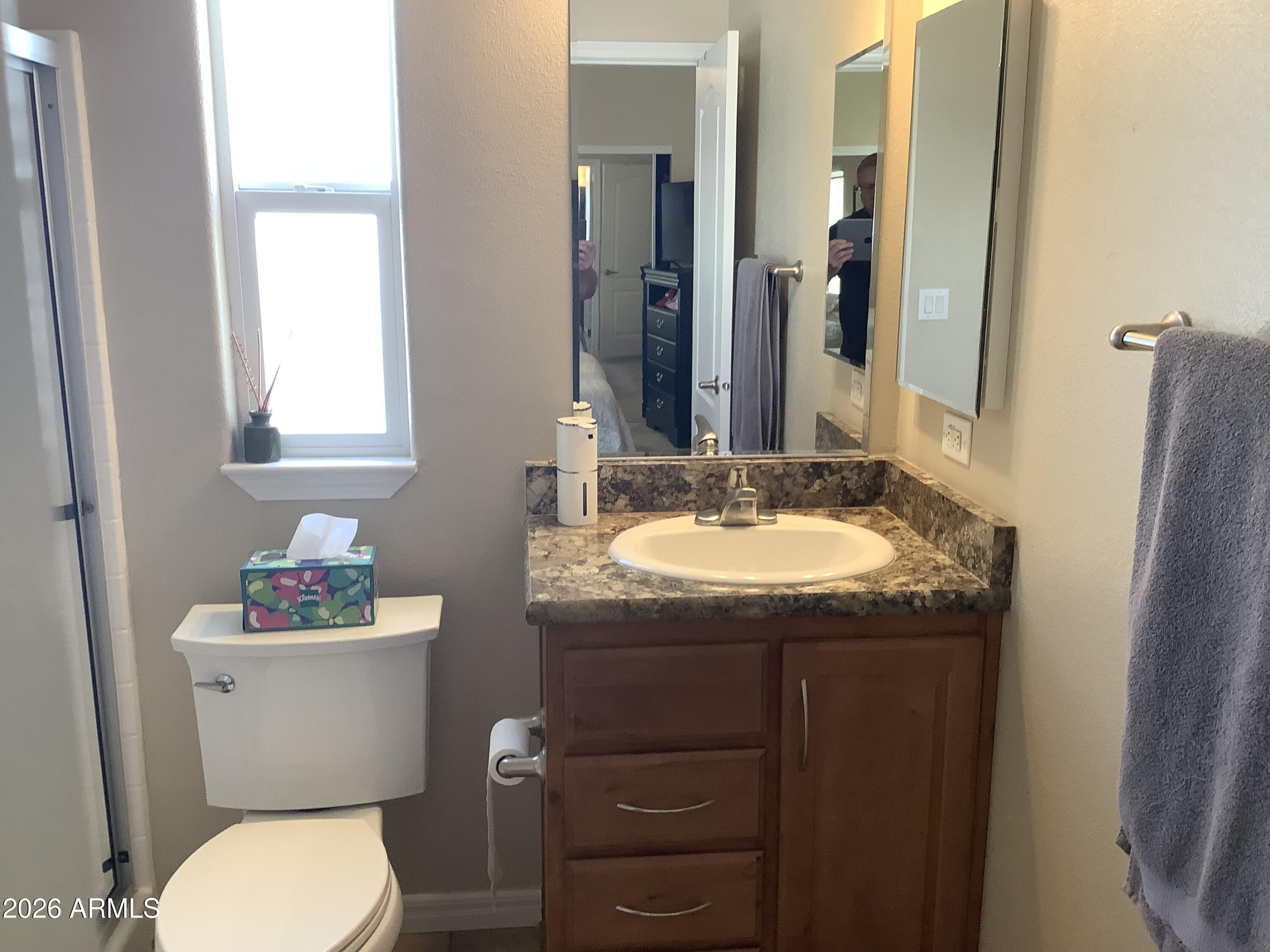 650 North Hawes Road, Unit 4007 Mesa, AZ 85207 - Photo 27 of 42 a bathroom with a granite countertop toilet sink and mirror