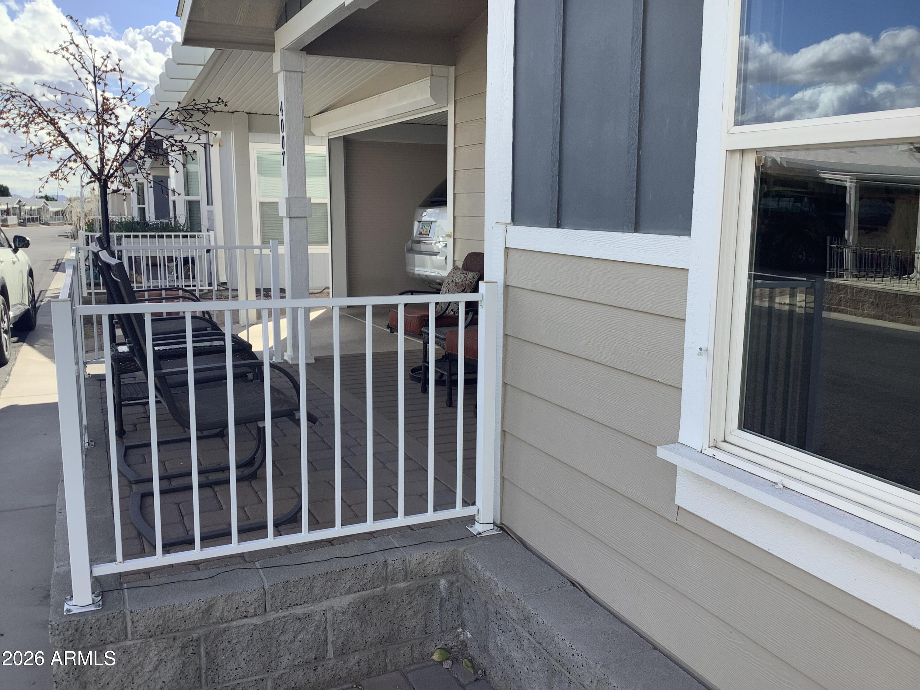 650 North Hawes Road, Unit 4007 Mesa, AZ 85207 - Photo 30 of 42 a view of a house with a small yard and wooden floor and fence