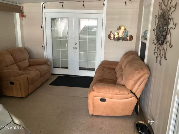 a living room with furniture and wall painting