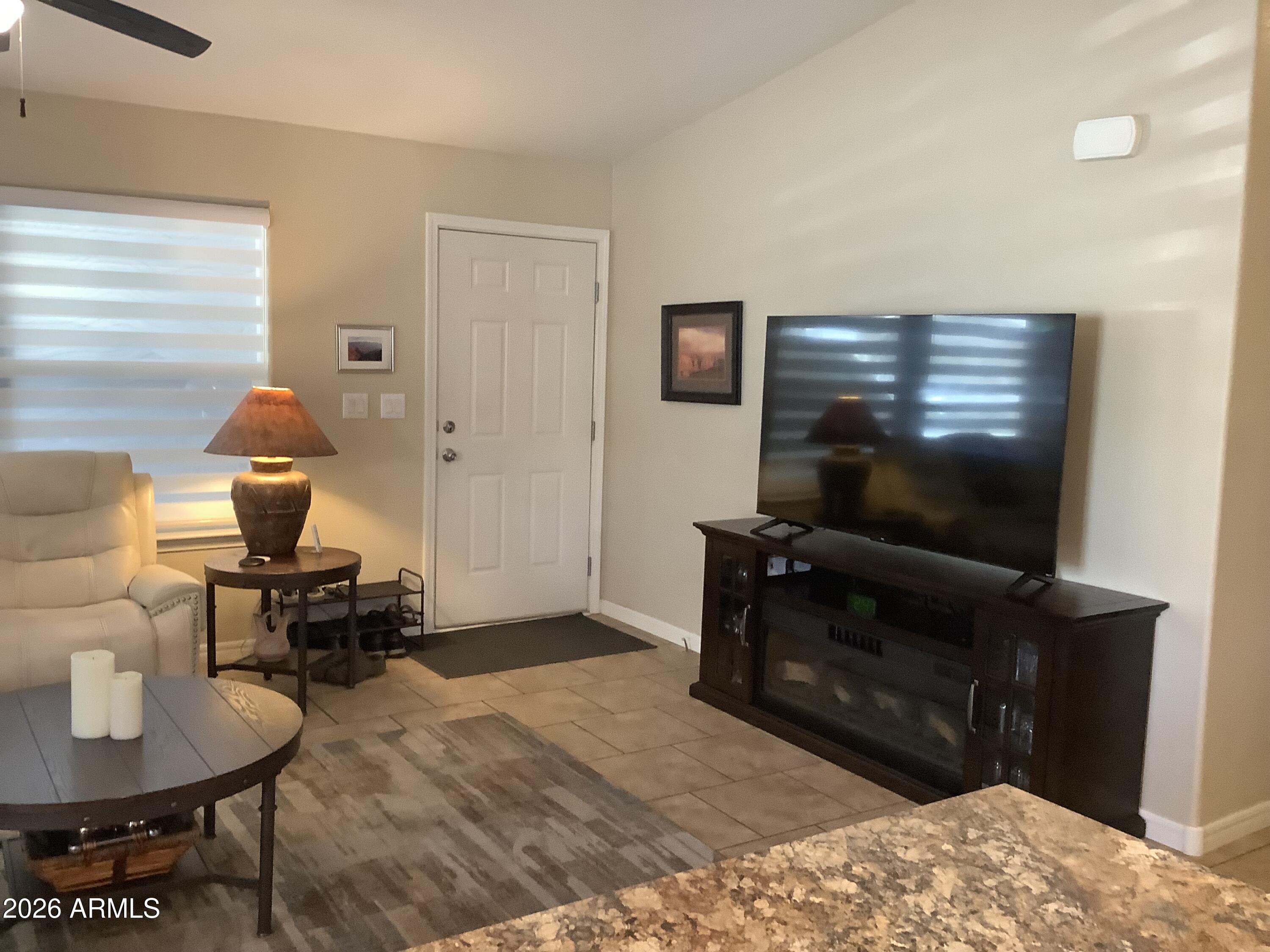 650 North Hawes Road, Unit 4007 Mesa, AZ 85207 - Photo 6 of 42 a living room with furniture and a flat screen tv