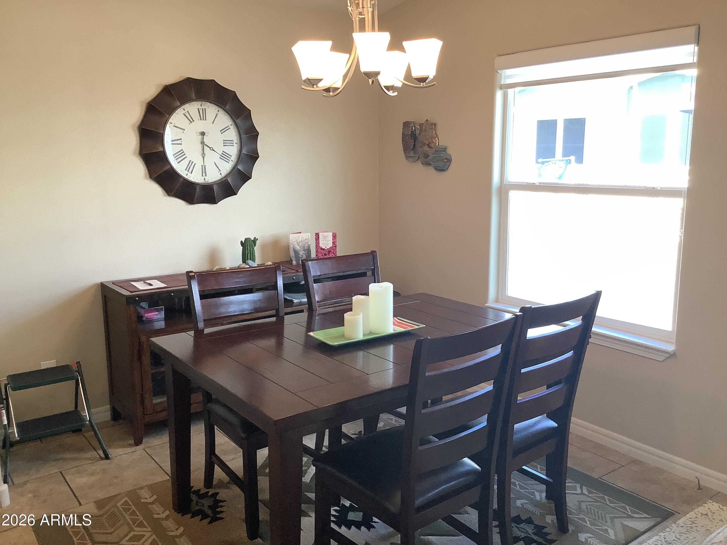 650 North Hawes Road, Unit 4007 Mesa, AZ 85207 - Photo 7 of 42 a view of a dining table and chairs in a room