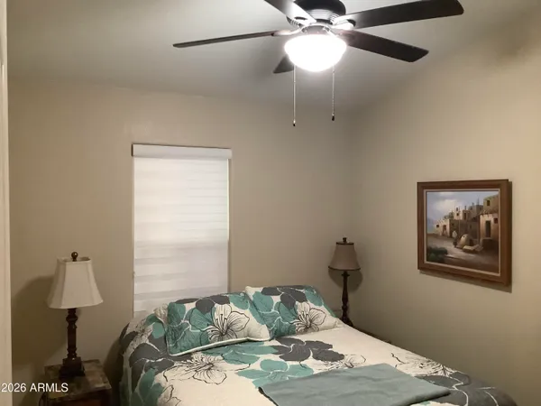 a bedroom with a bed and a lamp on the table