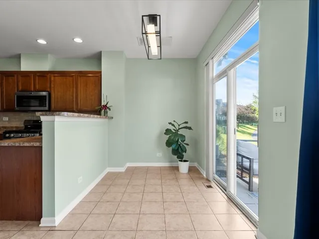 a hallway with a dining table and a potted plant