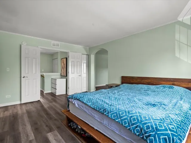 a bedroom with a bed and cabinet