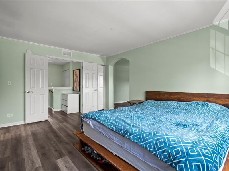 2147 Pembridge Lane Joliet, IL 60431 - Photo 17 of 34 a bedroom with a bed and cabinet