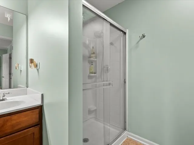 a bathroom with a shower and a sink