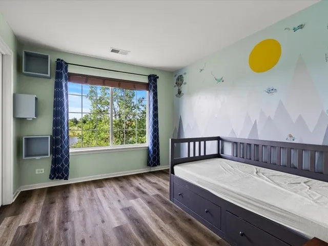 a view of a room with wooden floor and window