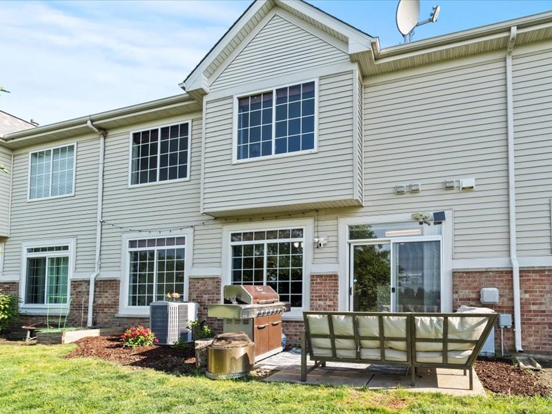 2147 Pembridge Lane Joliet, IL 60431 - Photo 25 of 34 a view of a house with couches chairs and swimming pool in front of house