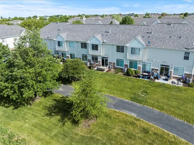 an aerial view of a house with a yard table and chairs