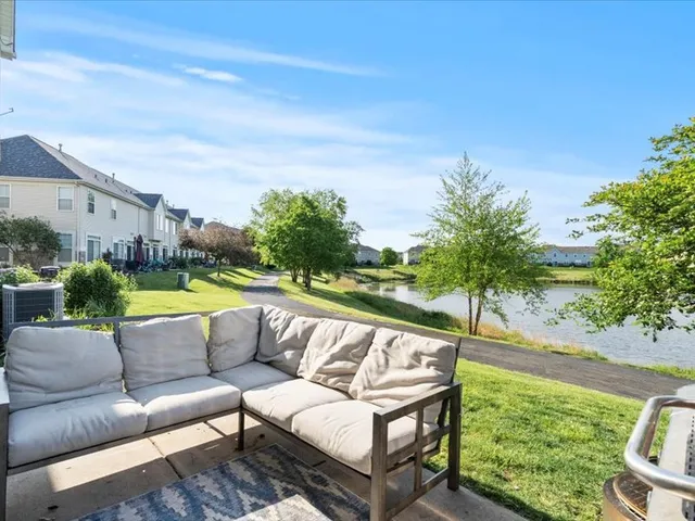 a view of swimming pool with couches and palm trees