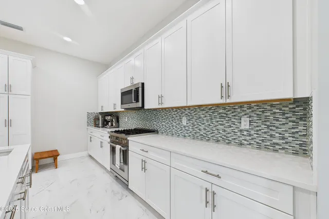 a bed room with a bed and a chair