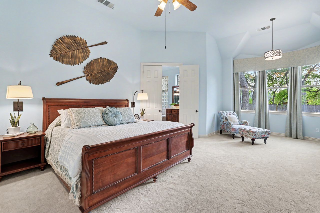 2828 Collingwood Drive Round Rock, TX 78665 - Photo 16 of 38 a spacious bedroom with a bed and a chandelier