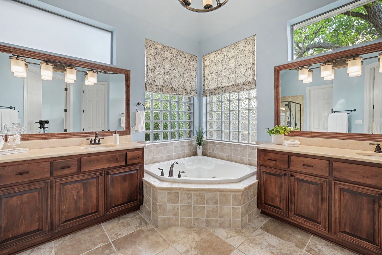 2828 Collingwood Drive Round Rock, TX 78665 - Photo 18 of 38 a spacious bathroom with a tub sink and mirror