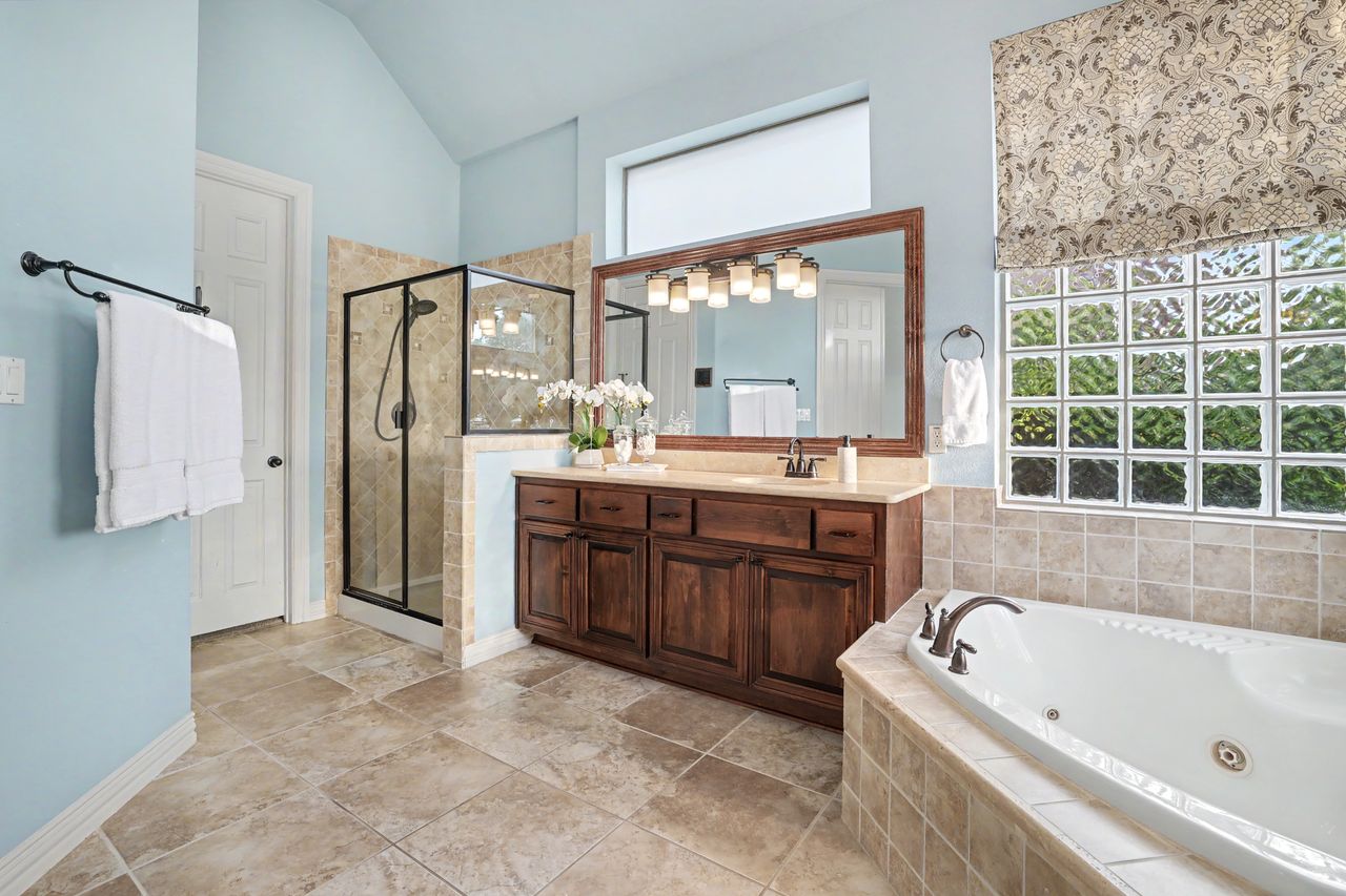 2828 Collingwood Drive Round Rock, TX 78665 - Photo 19 of 38 a spacious bathroom with a tub sink and mirror