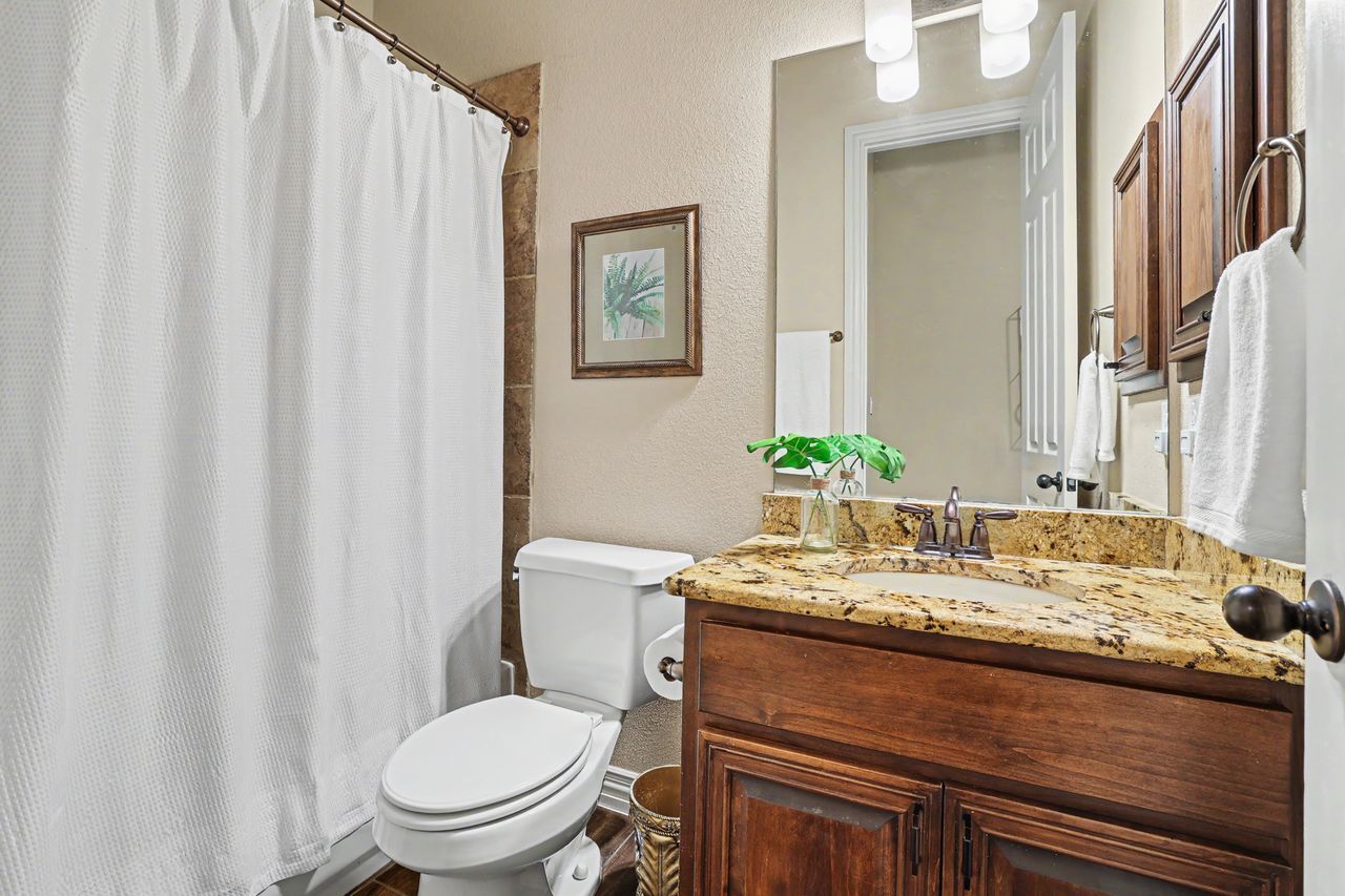 2828 Collingwood Drive Round Rock, TX 78665 - Photo 21 of 38 a bathroom with a granite countertop sink and a toilet