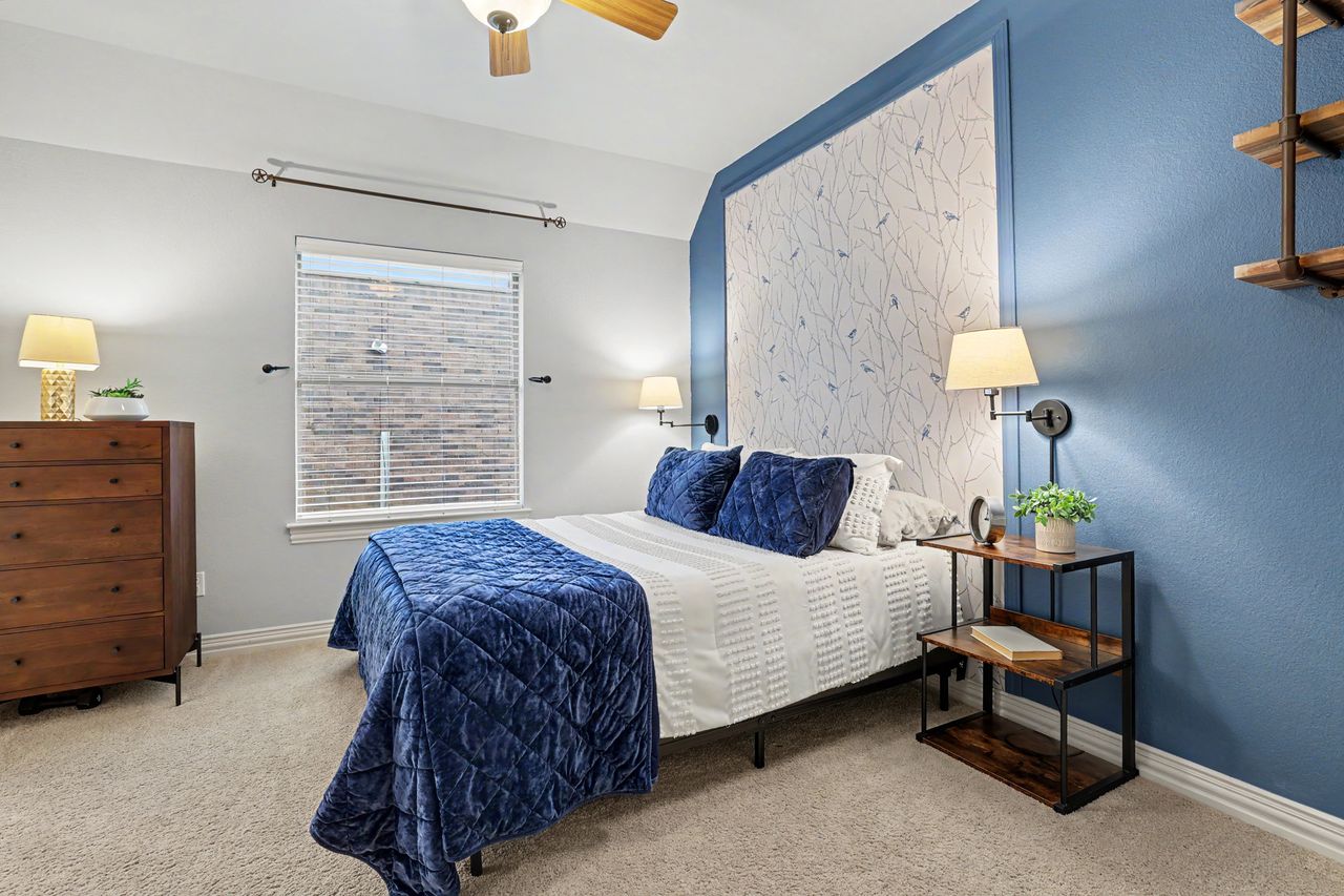 2828 Collingwood Drive Round Rock, TX 78665 - Photo 26 of 38 a bedroom with a bed and a chandelier