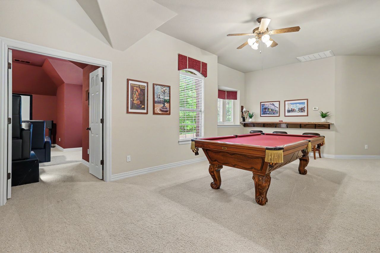 2828 Collingwood Drive Round Rock, TX 78665 - Photo 27 of 38 a living room with furniture and a chandelier