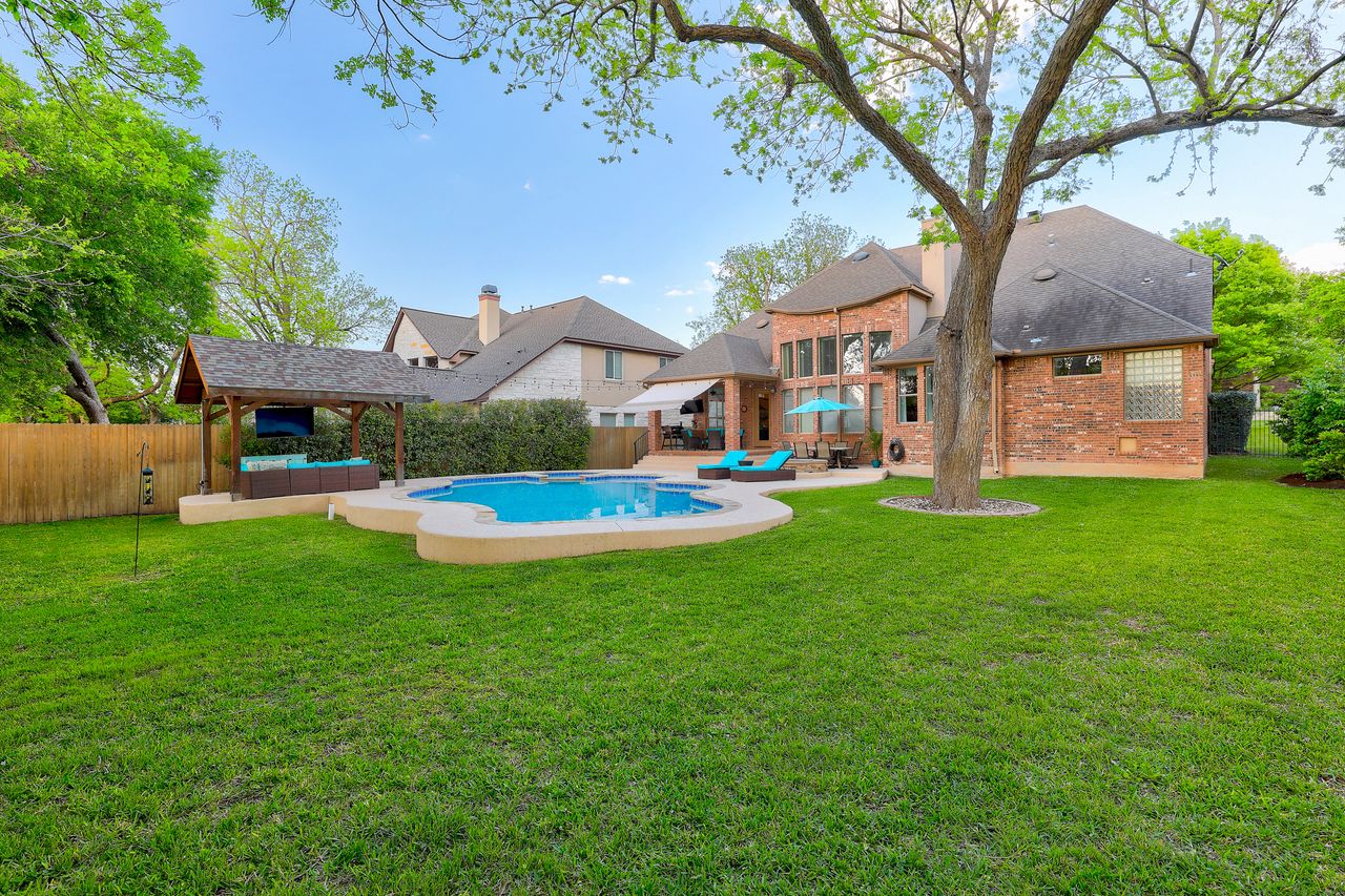 2828 Collingwood Drive Round Rock, TX 78665 - Photo 38 of 38 a view of a house with a big yard potted plants and a large tree