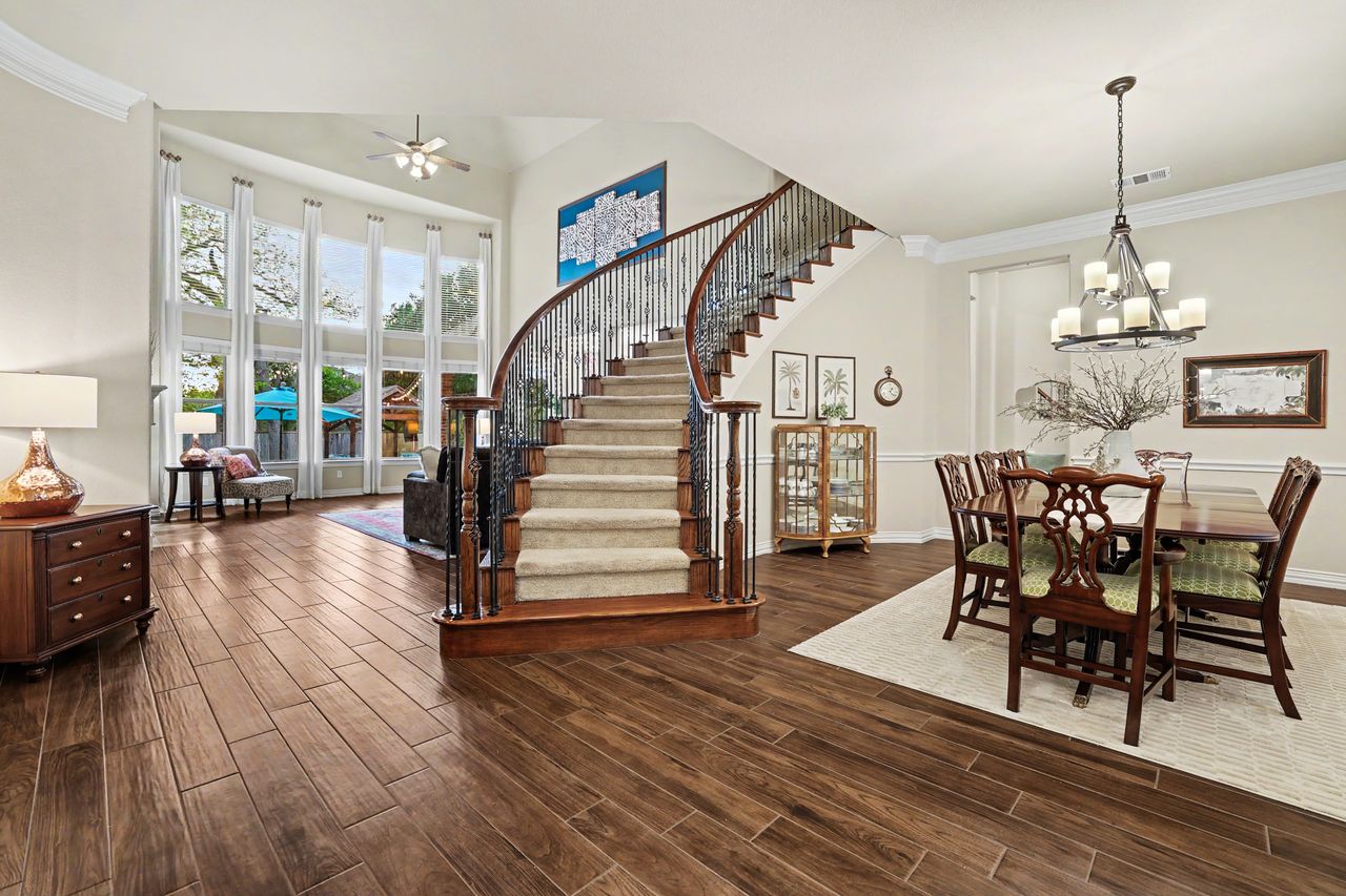 2828 Collingwood Drive Round Rock, TX 78665 - Photo 5 of 38 a view of a dining room and livingroom with furniture wooden floor a chandelier