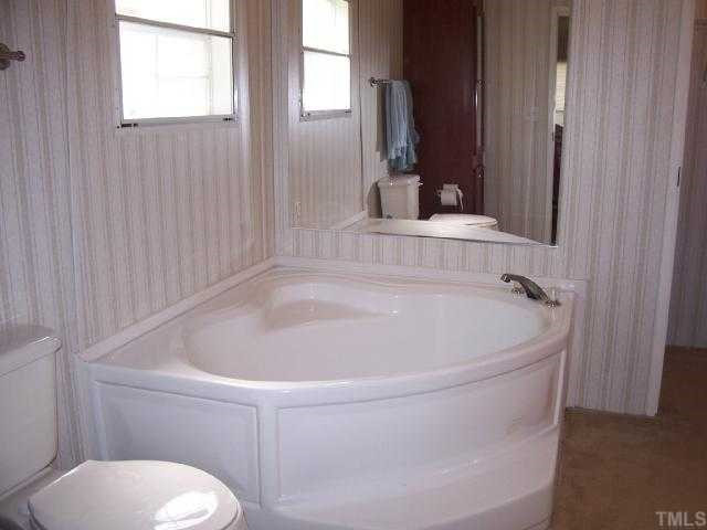 730 Creech Johnson Road Zebulon, NC 27597 - Photo 5 of 12 Master bath has tub and seperate shower. Walk in closet with extra cabinets and more. Master Bath/Spa