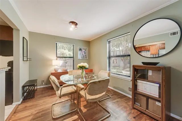 a dining room with furniture a mirror and a flat screen tv