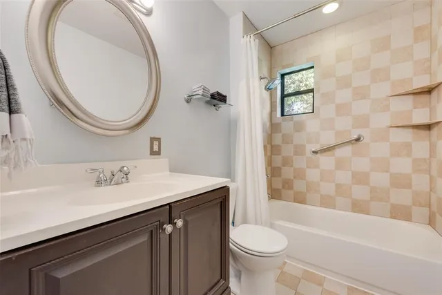 a bathroom with a toilet a sink and a window