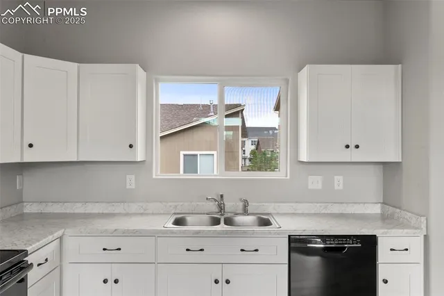 a kitchen with cabinets appliances a sink and a stove