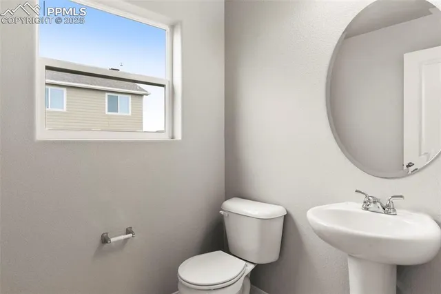 a bathroom with a sink toilet and a mirror