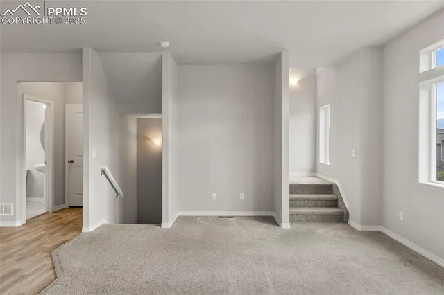 a view of an empty room with a fireplace