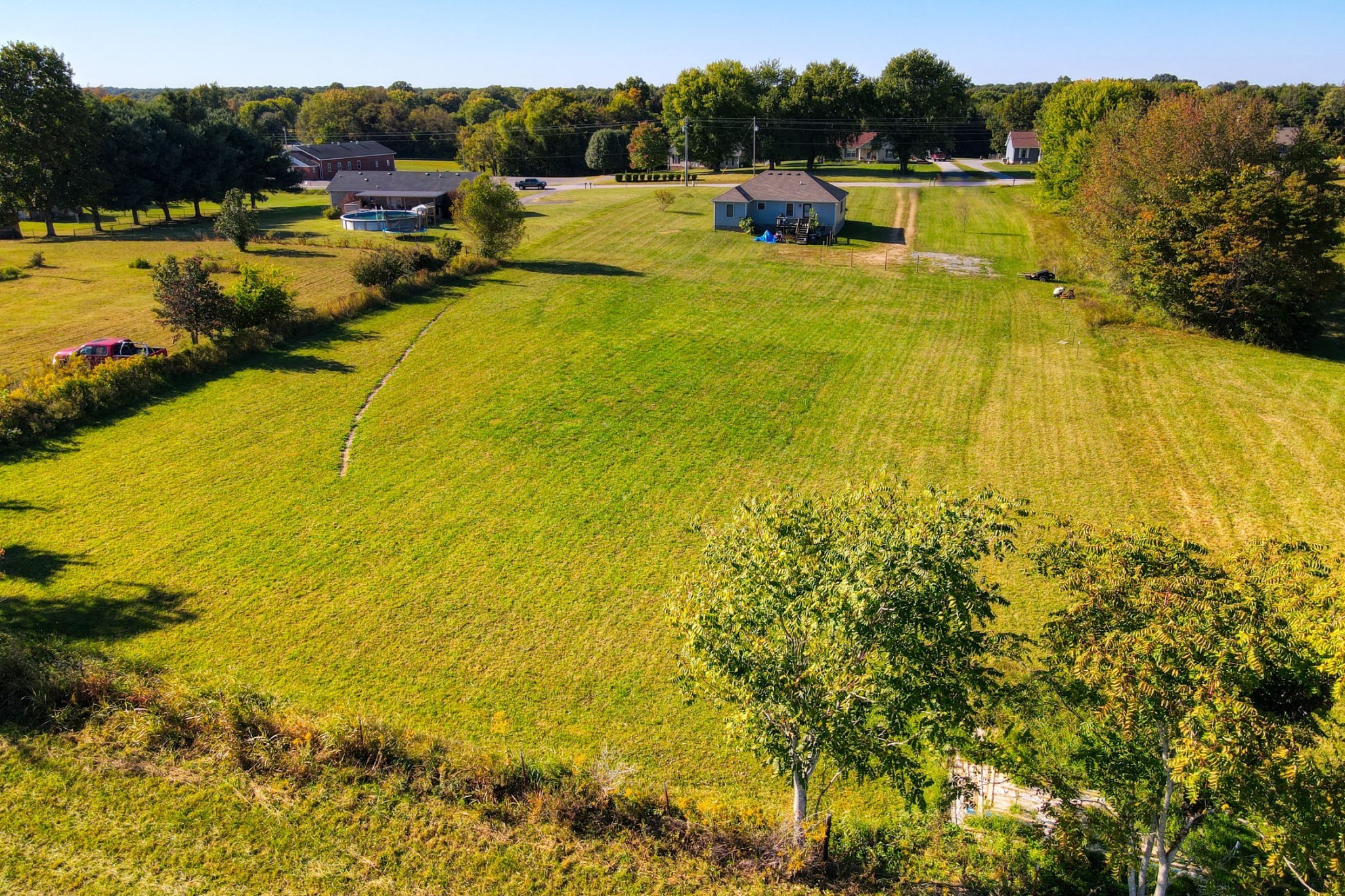 3678 Galen Road Lafayette, TN 37083 - Photo 3 of 23 a view of a swimming pool with a yard and trees