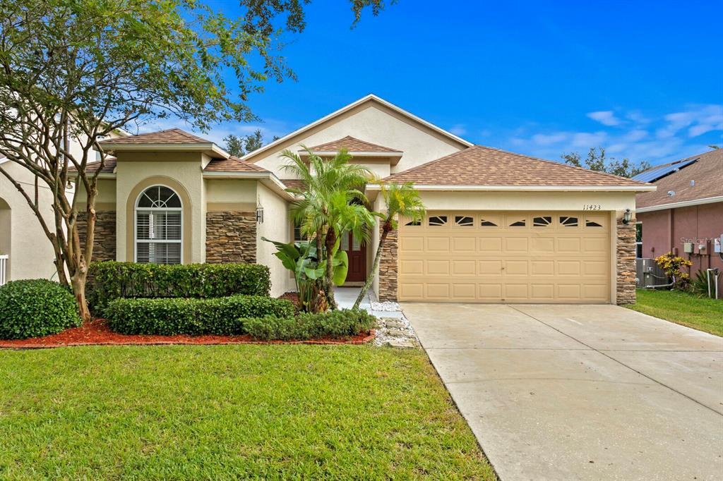 11423 Weston Course Loop Riverview, FL 33579 - Photo 1 of 1 a front view of a house with a yard and garage