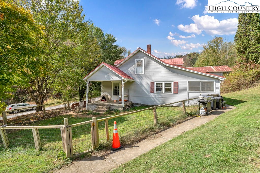 a front view of house with deck and yard
