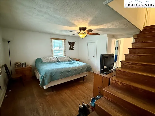 a bedroom with a bed and a view of balcony
