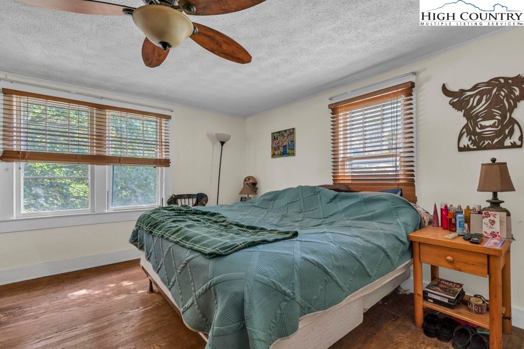 1068 Laurel Branch Road Vilas, NC 28692 - Photo 12 of 33 a bedroom with a bed and wooden floor