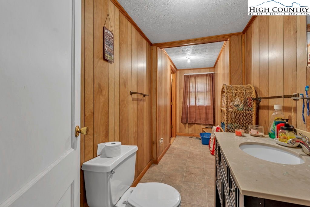 1068 Laurel Branch Road Vilas, NC 28692 - Photo 16 of 33 a bathroom with a toilet sink and mirror