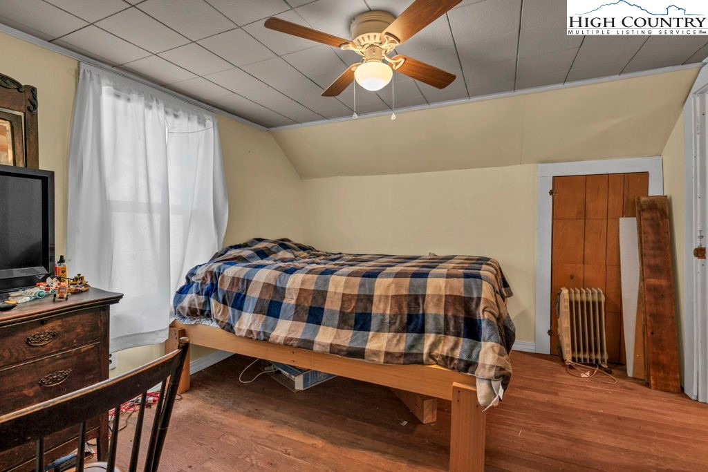 1068 Laurel Branch Road Vilas, NC 28692 - Photo 17 of 33 a bedroom with a bed table and a flat screen tv